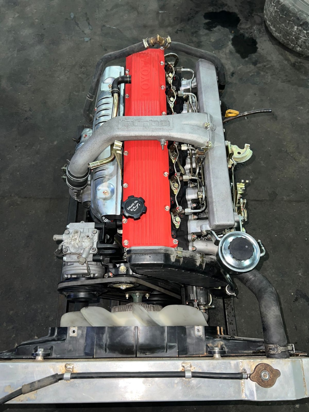 Rebuilt 1HD-T turbo diesel engine top-down view with red valve cover — Land Cruiser Heaven